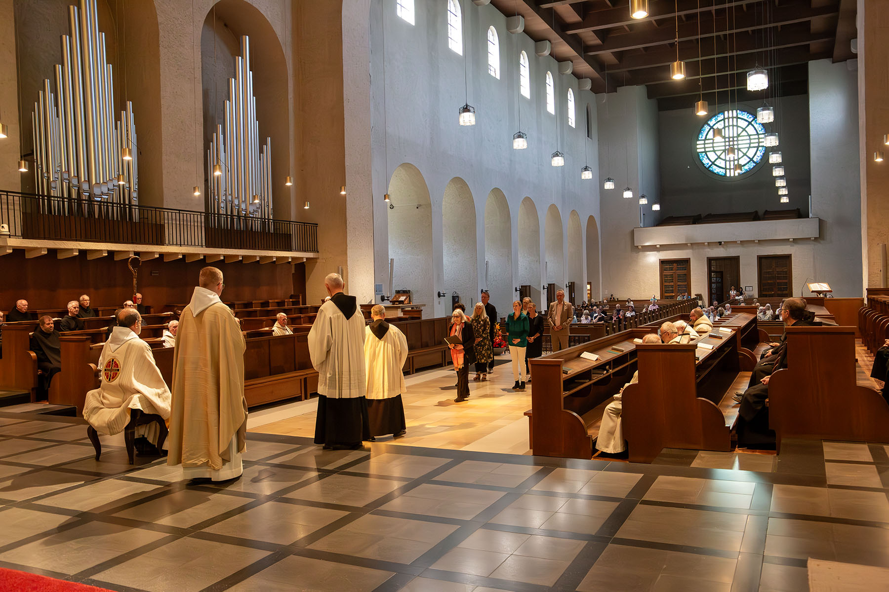 Blick über die Priester im Altarraum in die Kirche